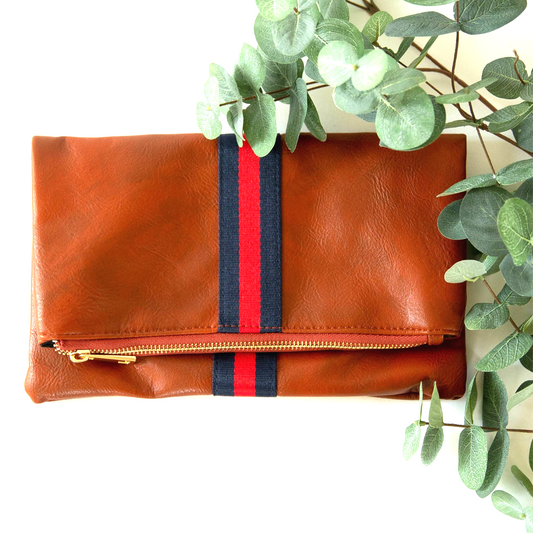 Caramel brown pu leather foldover wristlet with blue/red canvas preppy strap.